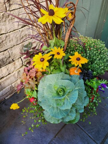 Porch of home in Pewaukee WI professionally planted for fall