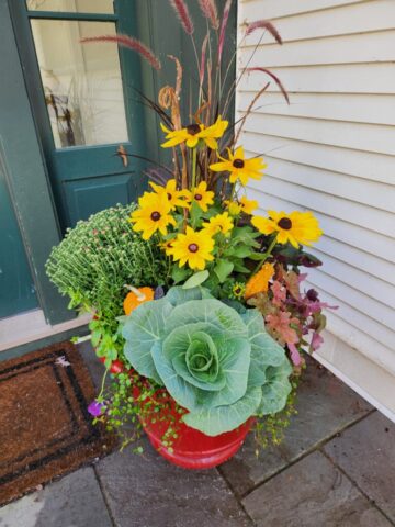Porch of home in Pewaukee WI professionally planted for fall