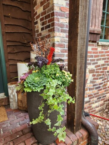 Front porch of home in Pewaukee WI custom designed planter planted for fall